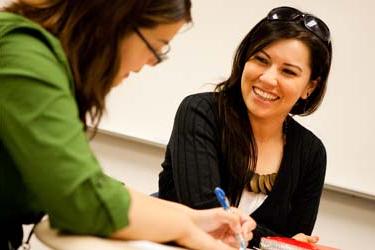 Two students laugh together while studying at San José State University.